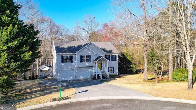 bi-level home featuring an attached garage and driveway