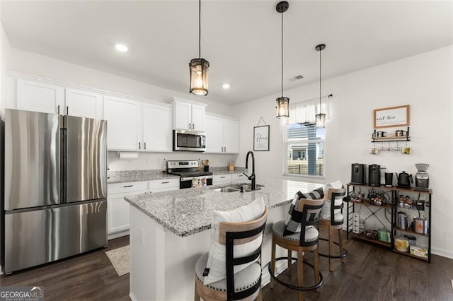 kitchen featuring white cabinets, dark wood-style floors, stainless steel appliances, and a sink