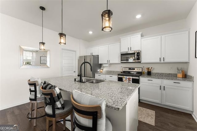 kitchen featuring dark wood-style floors, white cabinetry, appliances with stainless steel finishes, and a sink