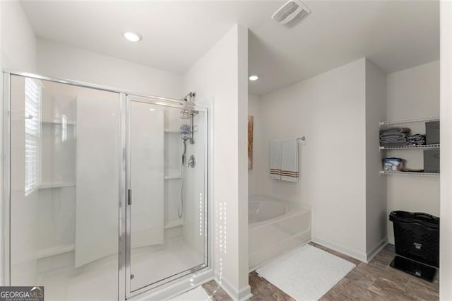 full bathroom with a stall shower, visible vents, and a bath