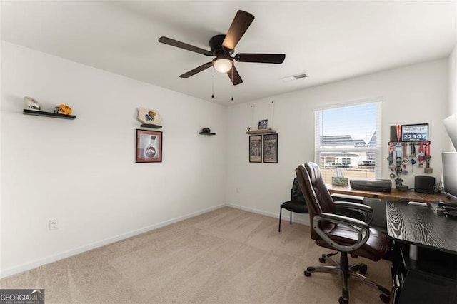 office featuring light carpet, baseboards, visible vents, and ceiling fan