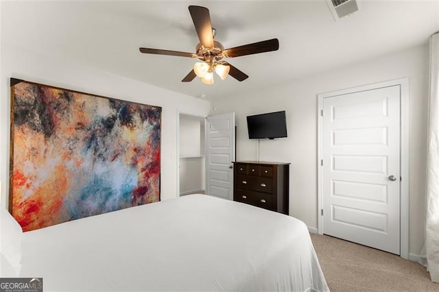 carpeted bedroom with visible vents, ceiling fan, and baseboards