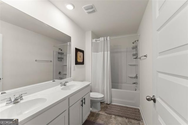 bathroom featuring toilet, shower / bath combo, visible vents, and a sink