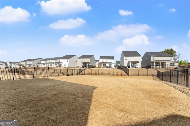 view of yard featuring a residential view and fence