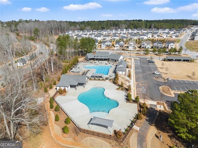 community pool featuring a residential view and a patio area