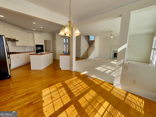 unfurnished living room with light wood-type flooring, a fireplace, and recessed lighting