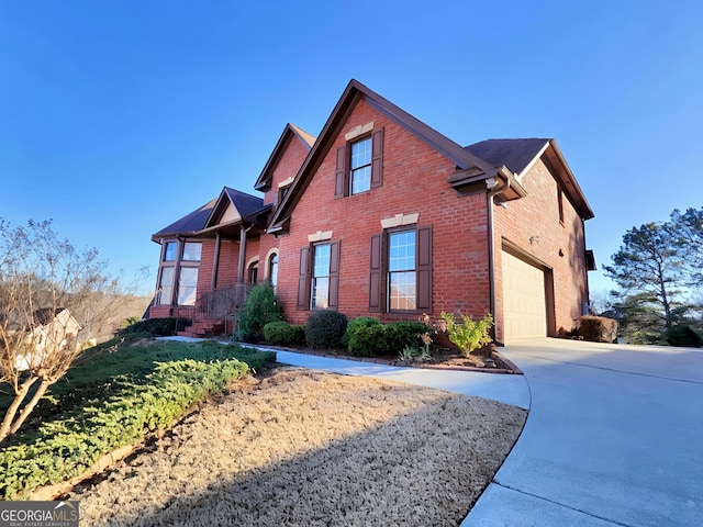 view of property exterior featuring a garage, concrete driveway, and brick siding