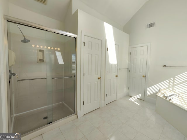 bathroom with a shower stall, visible vents, vaulted ceiling, and a bath