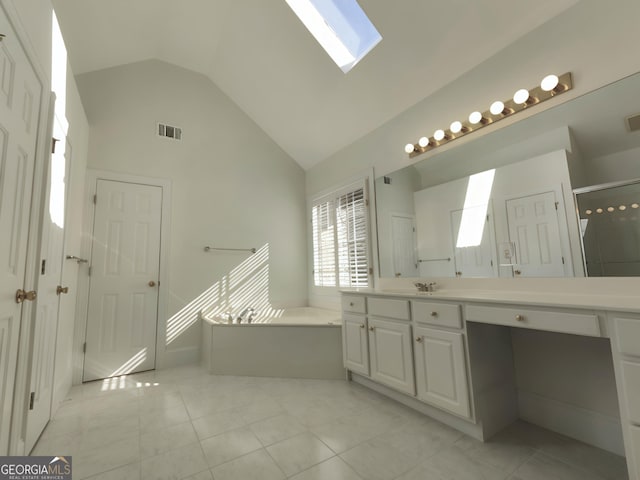 full bathroom with tile patterned flooring, a skylight, visible vents, vanity, and a bath