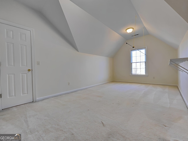 additional living space featuring carpet floors, lofted ceiling, visible vents, and baseboards