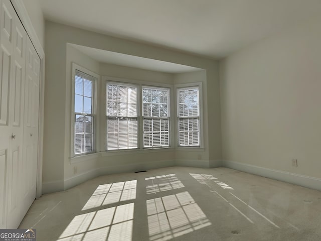 interior space with carpet floors, visible vents, and baseboards