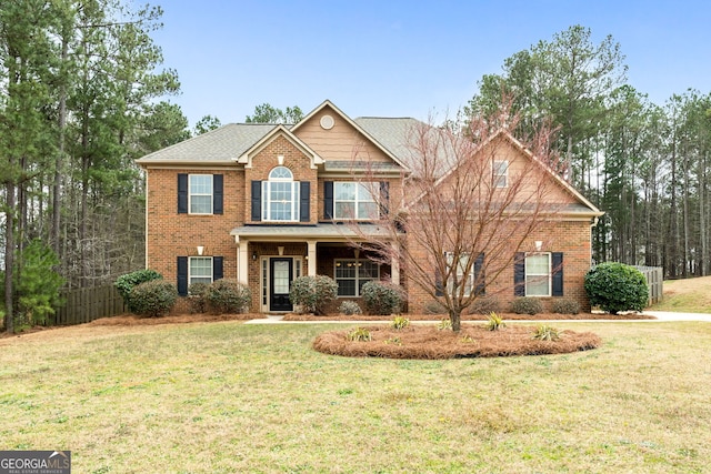 view of front of house featuring a front yard and brick siding