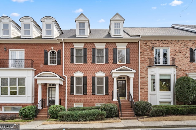 townhome / multi-family property with brick siding