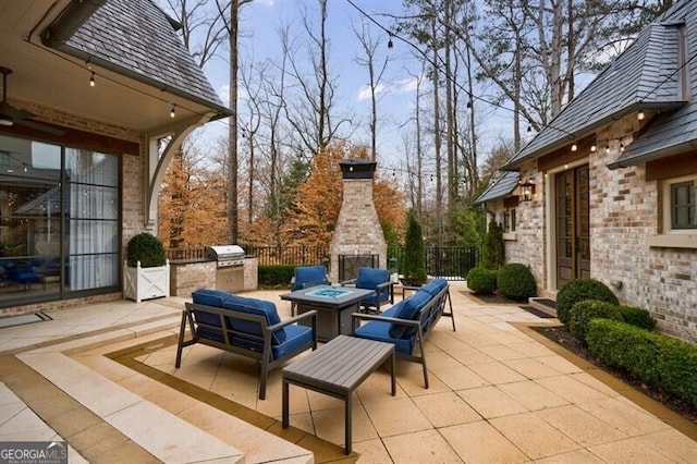 view of patio / terrace with an outdoor fire pit, a grill, fence, and area for grilling