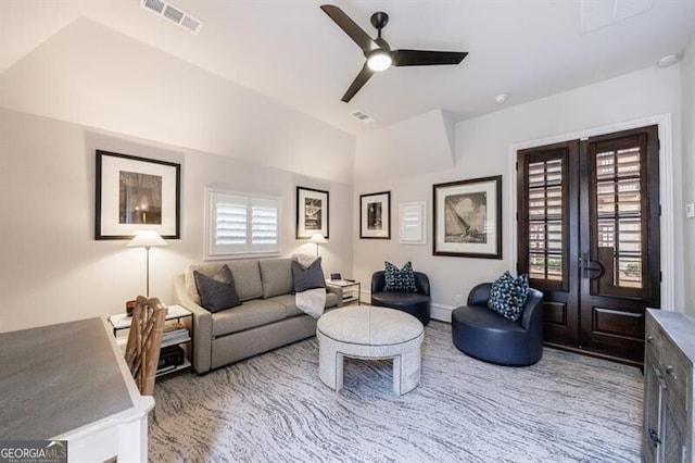 living room with visible vents, vaulted ceiling, a ceiling fan, and french doors