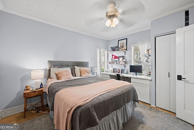 1015 Michigan Ave NW, Atlanta, GA 30314 - bedroom with light wood-style flooring, ornamental molding, a ceiling fan, an office area, and a closet