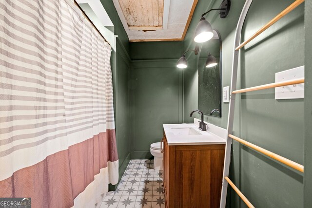 1015 Michigan Ave NW, Atlanta, GA 30314 - bathroom featuring tile patterned floors, toilet, vanity, and curtained shower