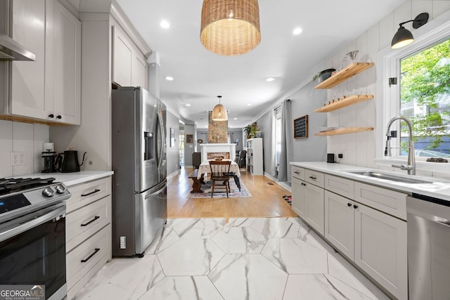 1015 Michigan Ave NW, Atlanta, GA 30314 - kitchen with appliances with stainless steel finishes, a sink, wall chimney exhaust hood, light countertops, and recessed lighting