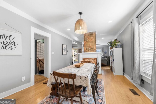 1015 Michigan Ave NW, Atlanta, GA 30314 - dining area with light wood-style flooring, a fireplace, baseboards, and recessed lighting
