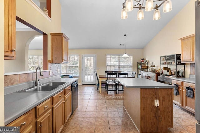 kitchen featuring a center island, arched walkways, light tile patterned floors, a sink, and dishwasher