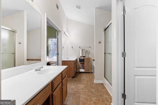 full bath with a stall shower, a sink, visible vents, and tile patterned floors