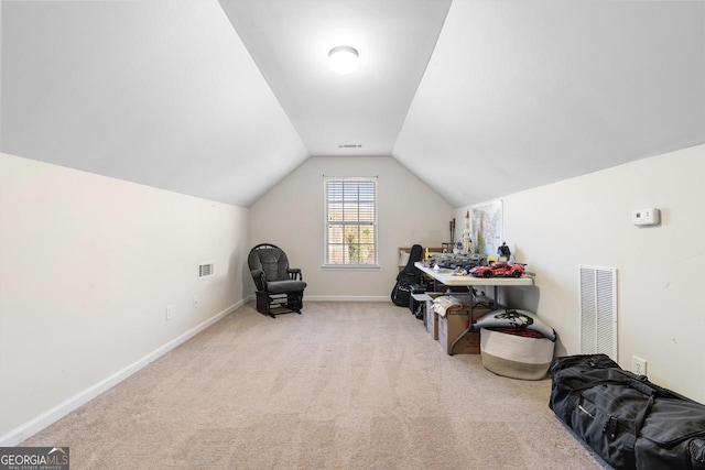 interior space with vaulted ceiling, carpet floors, visible vents, and baseboards