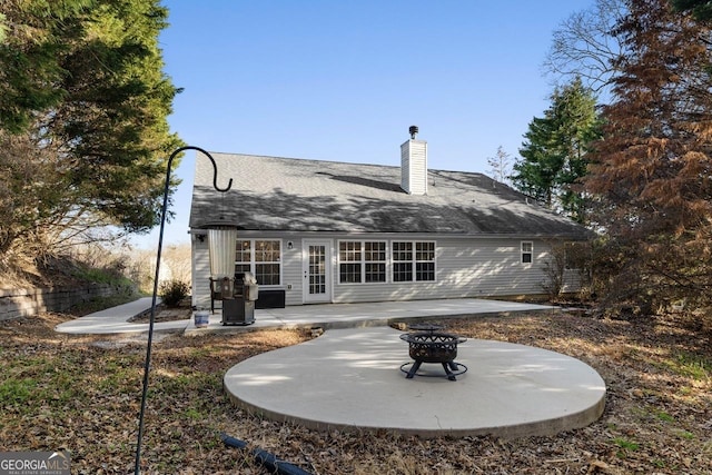 back of house with a patio area, an outdoor fire pit, and a chimney