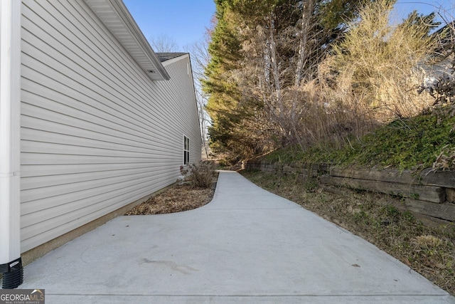 view of property exterior with a patio area