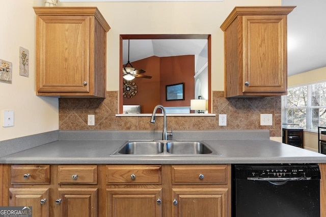 kitchen with black dishwasher, brown cabinets, a sink, and backsplash