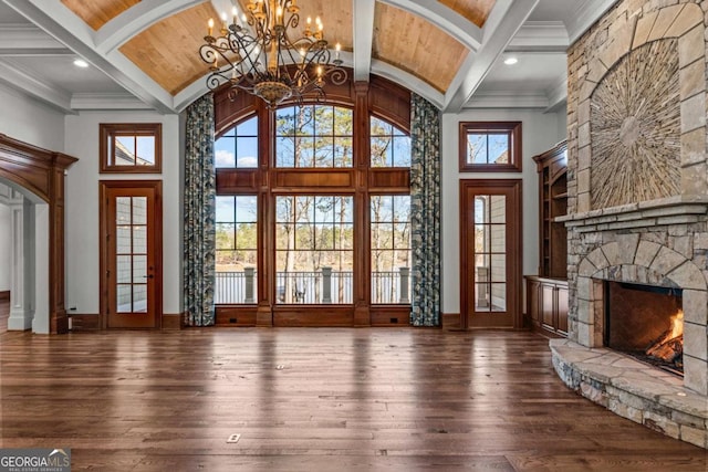 unfurnished living room with high vaulted ceiling, a fireplace, wood-type flooring, and beam ceiling