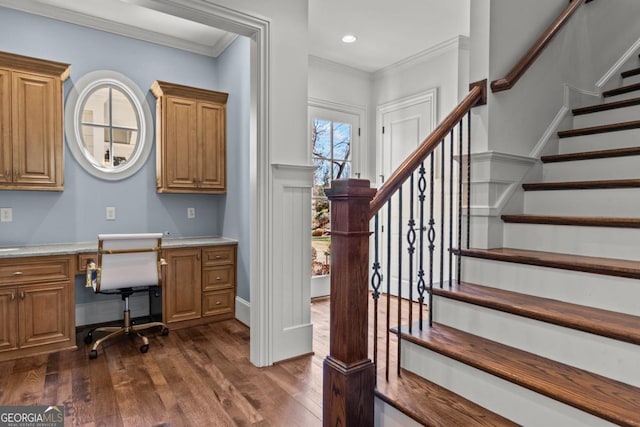 office with ornamental molding, dark wood-type flooring, built in desk, and recessed lighting