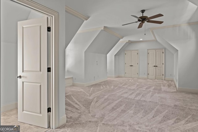 bonus room with carpet floors, vaulted ceiling, baseboards, and a ceiling fan