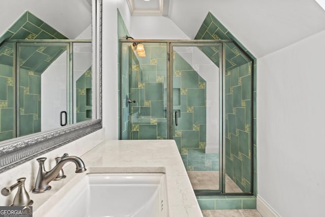 bathroom featuring vaulted ceiling, a stall shower, a sink, and a bath