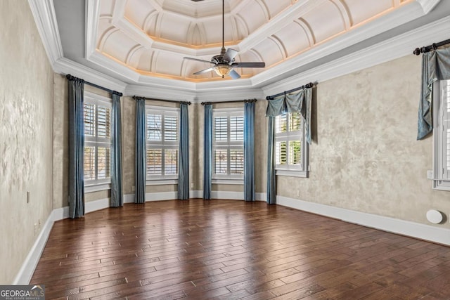 spare room with hardwood / wood-style floors, baseboards, ornamental molding, and a ceiling fan