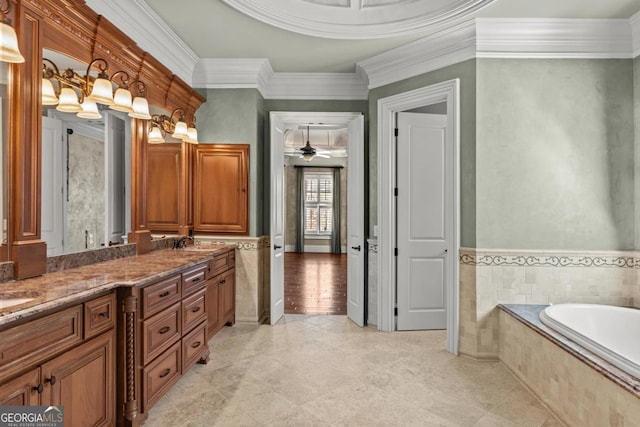 bathroom featuring double vanity, tile walls, wainscoting, a sink, and a bath