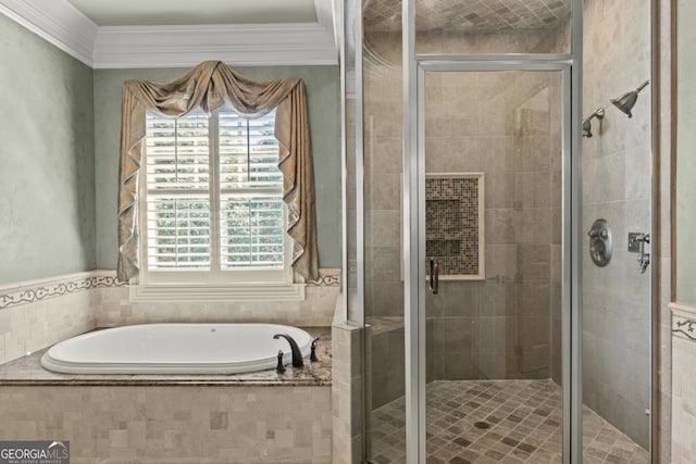 bathroom featuring a garden tub, crown molding, and a shower stall