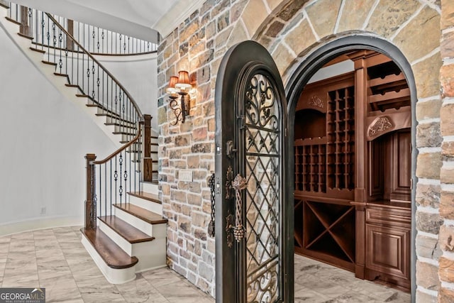 wine room with marble finish floor and baseboards