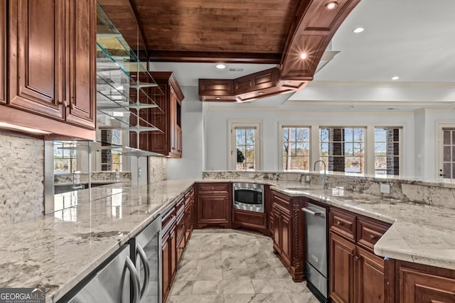 kitchen with beverage cooler, appliances with stainless steel finishes, backsplash, light stone countertops, and a sink