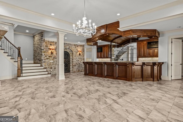 reception area featuring an inviting chandelier, decorative columns, stairway, and arched walkways