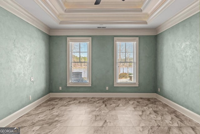 unfurnished room featuring a healthy amount of sunlight, visible vents, a tray ceiling, and ceiling fan