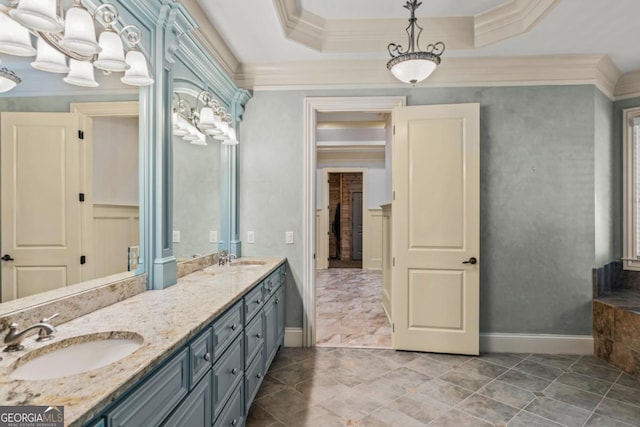 bathroom featuring baseboards, ornamental molding, and a sink