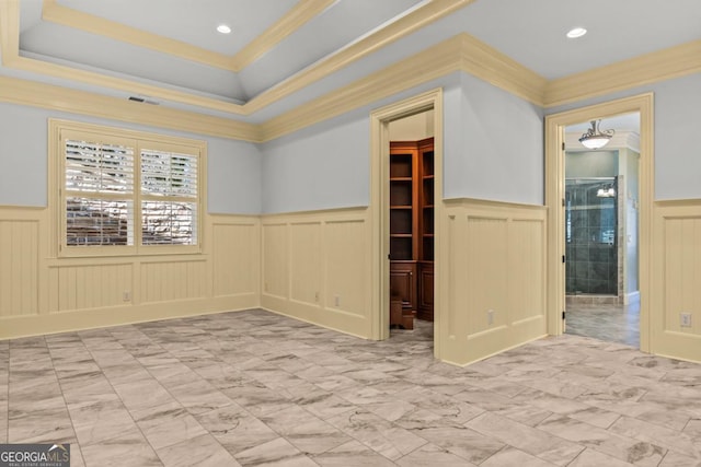 unfurnished room featuring marble finish floor, recessed lighting, visible vents, ornamental molding, and wainscoting