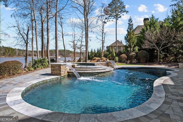 outdoor pool with a water view and an in ground hot tub