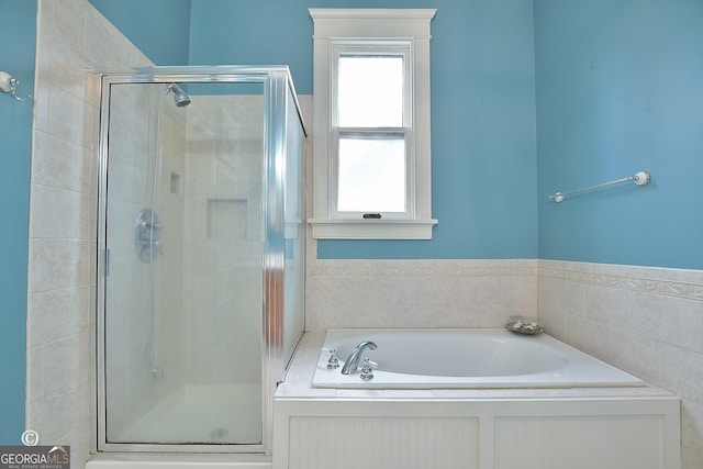 bathroom with a garden tub and a shower stall