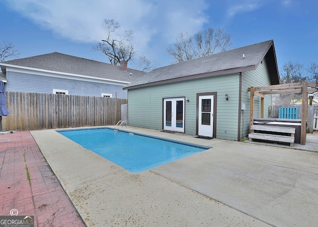 view of pool with a fenced backyard, a patio, a pergola, and french doors