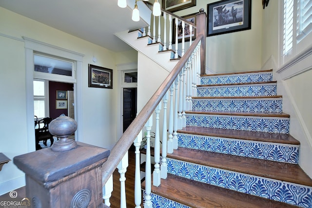 stairs featuring wood finished floors