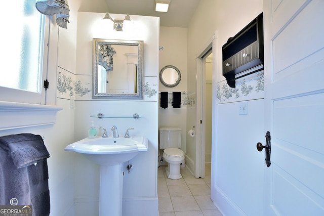 bathroom featuring a sink, toilet, and tile patterned floors