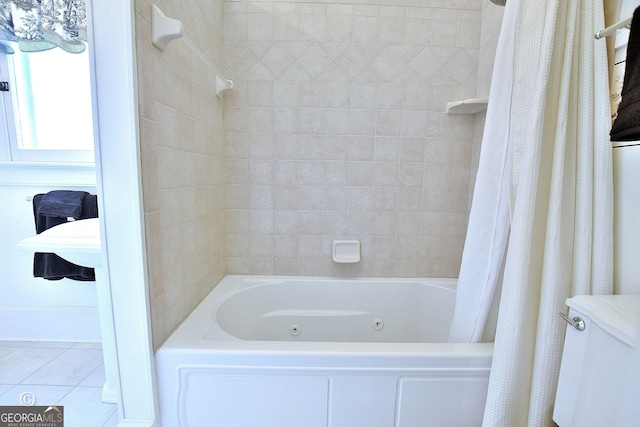 bathroom featuring tile patterned flooring and a combined bath / shower with jetted tub