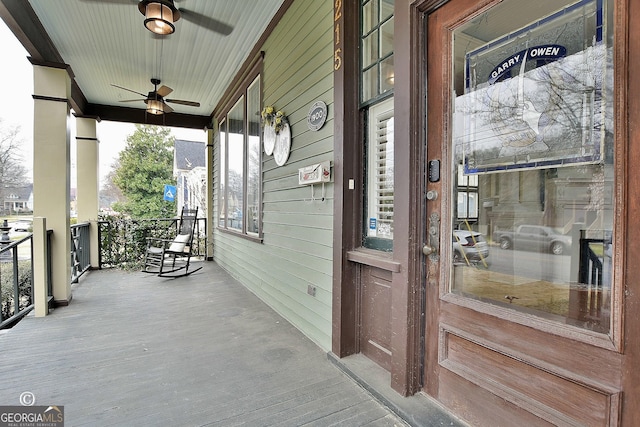 wooden deck featuring a porch and a ceiling fan