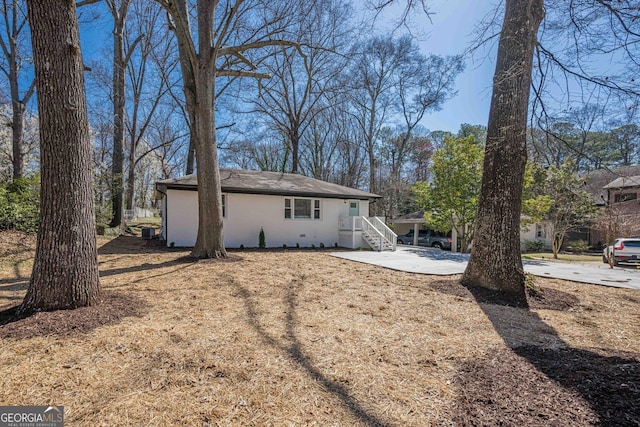 rear view of property featuring central AC unit